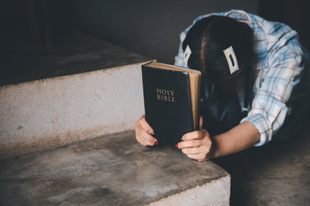 Female kneeling down praying for worship God at home. Christians pray to jesus christ for calmness. people got to quiet place and worship. Christians humble and submit to God. Banner with copy space.の写真素材