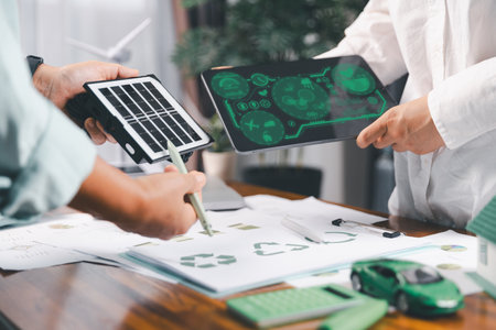 Business people working on sustainable innovation project. renewable energy concept. Teamwork Meeting, partner on model building company office technology, based green businesses and global warming.の写真素材