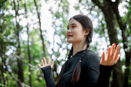 Grateful woman having HOPE. Spiritual girl smiling to sky. Happy female being thankful. Spiritual girl praying with hope. Positive Asian young woman feeling hope and faith looking up.の写真素材
