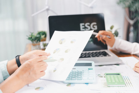 Business people working on sustainable innovation project. renewable energy concept. Teamwork Meeting, partner on model building company office technology, based green businesses and global warming.の写真素材