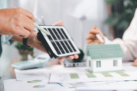Business people working on sustainable innovation project. renewable energy concept. Teamwork Meeting, partner on model building company office technology, based green businesses and global warming.の写真素材
