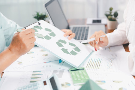 Business people working on sustainable innovation project. renewable energy concept. Teamwork Meeting, partner on model building company office technology, based green businesses and global warming.の写真素材