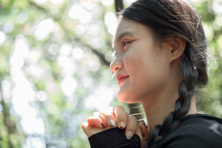 Grateful woman having HOPE praying to God. Spiritual girl smiling to sky. Happy female being thankful. Spiritual girl praying with hope. Positive Asian young woman feeling hope and faith looking up.の写真素材