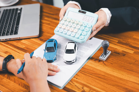 à¸ºBusinessman approval stamper stamp on paper business contract. car loan money approved. Dealer or manager gives car to customer sign car purchase document with insurance, contract to buy car legal.の写真素材