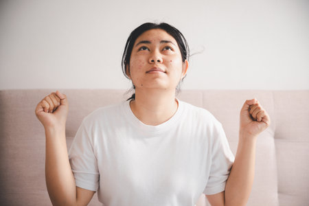 People and hope concept. Close up face female looking up feeling hope and faith. Woman praying....