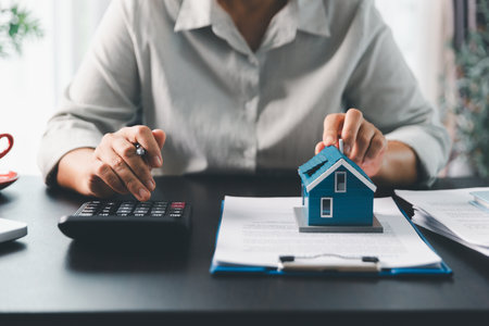 Real estate agent agree to buy home to clients agency office. House model, real estate agent, customer discussing for contract to buy house, insurance, loan real estate background. Concept agreement.の写真素材