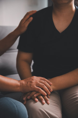 Hope and trust with crisis concept. Closeup, love and holding hands for support, comfort and care with grief, loss and empathy. people and family with compassion, sympathy and healing with bonding.の写真素材
