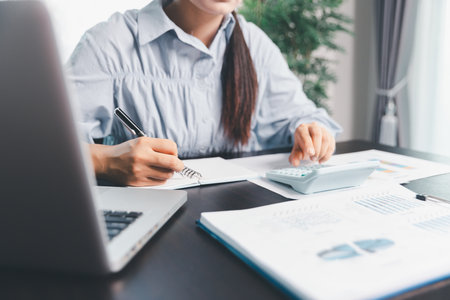 Business woman analyze calculate company financial, tax results office accounting statistics analytical research. calculating business balance prepare tax reduction. Tax deduction planning concept.の写真素材
