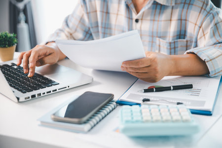 Woman calculating monthly home expenses, taxes, bank account balance and credit card bills payment, Income is not enough for expenses. financial planning, business calculate tax, investment finance.の写真素材