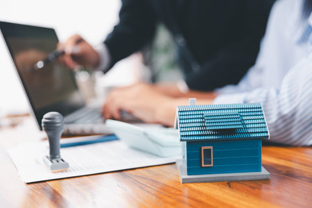 Bank approve loan to buy home concept. Real estate agent talked about terms of home purchase agreement, asked customer to sign documents to make contract legally. approved mortgage application form.の写真素材