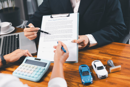 à¸ºBusinessman approval stamper stamp on paper business contract. car loan money approved. Dealer or manager gives car to customer sign car purchase document with insurance, contract to buy car legal.の写真素材
