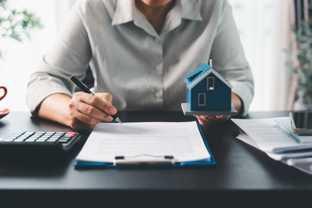 Real estate agent agree to buy home to clients agency office. House model, real estate agent, customer discussing for contract to buy house, insurance, loan real estate background. Concept agreement.の写真素材