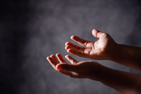 Christian woman lifts her hand in worship to pray, hope, faith, and deep belief in God defines core...