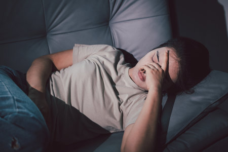 Sorrowful woman sat alone, overwhelmed by emotion, her sad and unhappy expression revealing deep despair, stress and distress left feeling depressed. sorrowful sad, despair alone, depressed stressの写真素材