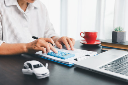 Concept of automobile ownership involves managing expenses such as insurance, tax, and loan payments, making car finance a key part of personal saving and financial planning in today economy.の写真素材