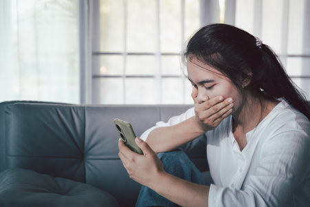 Sorrowful woman sat alone, overwhelmed by emotion, her sad and unhappy expression revealing deep despair, stress and distress left feeling depressed. sorrowful sad, despair alone, depressed stressの写真素材