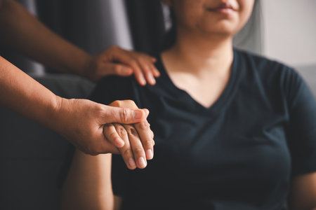 Hope and trust with crisis concept. Closeup, love and holding hands for support, comfort and care with grief, loss and empathy. people and family with compassion, sympathy and healing with bonding.の写真素材
