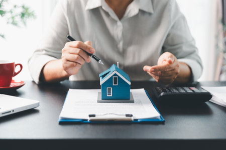 Real estate agent agree to buy home to clients agency office. House model, real estate agent, customer discussing for contract to buy house, insurance, loan real estate background. Concept agreement.の写真素材