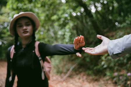 Two friends helping with teamwork trying to reach top of mountains during wonderful summer sunset. Teamwork couple hiking help each other trust assistance. Team of climbers two friends hiker.の写真素材