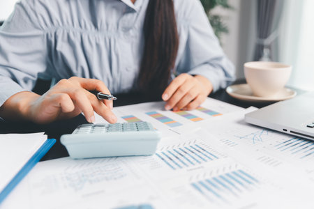 Business woman analyze calculate company financial, tax results office accounting statistics analytical research. calculating business balance prepare tax reduction. Tax deduction planning concept.の写真素材