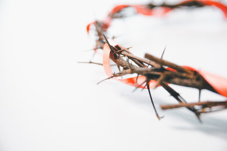 Crown of thorns on white table background. Easter, central celebration in Christianity, honors sacrifice of Jesus Christ, crown of thorns symbolizes redemption, faith, deep spirituality of religion.の写真素材