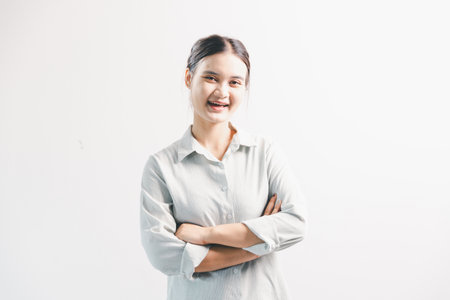 Asian woman rejoicing, looking happy, champion, fist pump gesture, standing over white background....