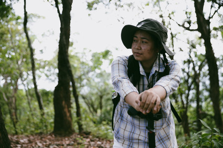 Young female traveler with backpack walking in national park or forest. recreation sport in nature....