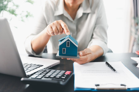 Real estate agent agree to buy home to clients agency office. House model, real estate agent, customer discussing for contract to buy house, insurance, loan real estate background. Concept agreement.の写真素材