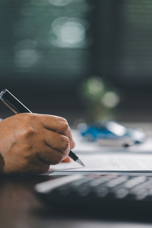 Client is signing the contract and insurance document for the purchase of a vehicle, finalizing...