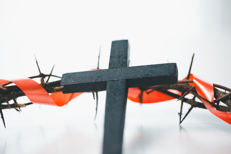 Cross and crown of thorns, often seen in gold crucifix symbols, represent the sacrifice of Jesus Christ-central to Easter message and the foundation of faith in the Christian religion.の写真素材