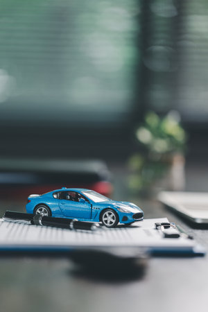 Car loan approval concept. Client finalizes purchase of vehicle by signing contract includes auto loan, insurance, credit terms, making car smart financial investment business-backed finance option.の写真素材