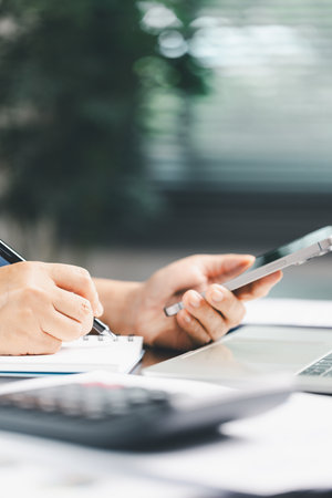 Consultant facilitates consultation between bookkeepers, lawyer to review accounting balance sheet, stock market statistics, yearly tax obligations, ensuring business is protected from bribery, law.の写真素材