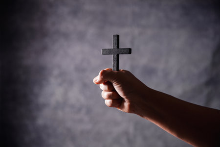 Christian woman lifts her hand in worship to pray, hope, faith, and deep belief in God defines core concept of religion. Praying hands with faith in religion, belief in God. Power of hope or love.の写真素材