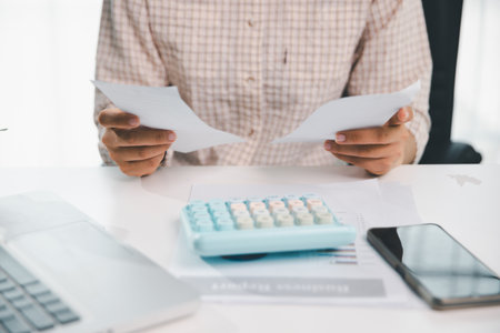 Woman calculating monthly home expenses, taxes, bank account balance and credit card bills payment, Income is not enough for expenses. financial planning, business calculate tax, investment finance.の写真素材