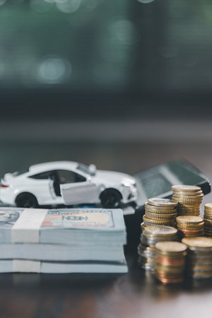 Euro car finance. car with calculator and money on wood table. insurance concept. investment and wealth accumulation through the symbolism of miniature car alongside coins.の写真素材