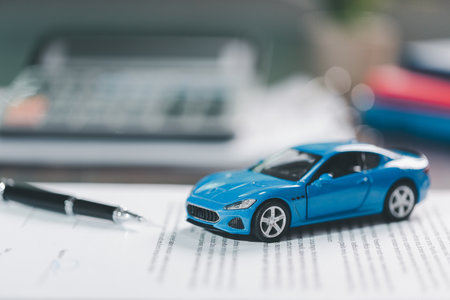 Client legal contract and finance document for business deal involving vehicle, agreements cover car loan, insurance, investment terms, with car key handed over to complete transaction.の写真素材