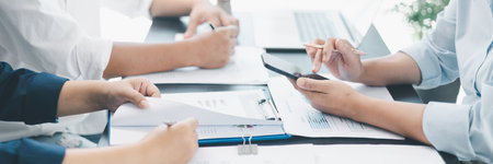 Panorama of corporate teamwork with people discussing financial reports, pointing at charts,...