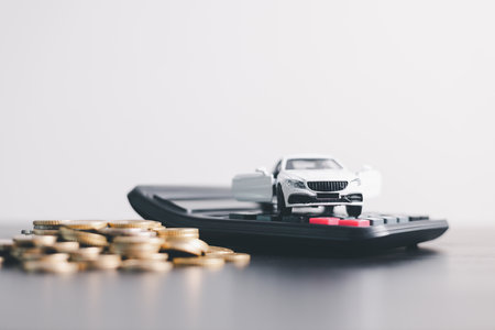 White car model with open door surrounded by stacked coins, symbolizing auto loan, car finance, investment, insurance, and savings concept on a clean minimal background. car financeの写真素材