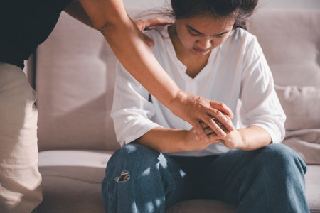 Moment of deep grief, sorrow and anxiety, lonely person overwhelmed by despair feels spark of hope when helping hand reaches out with genuine emotion to ease their problem.の写真素材