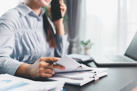 Business woman analyze calculate company financial, tax results office accounting statistics analytical research. calculating business balance prepare tax reduction. Tax deduction planning concept.の写真素材