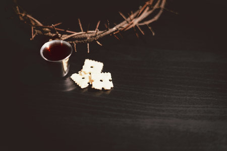 Communion bread and wine with the Holy Bible and crown of thorns, symbolizing the sacrifice of Jesus Christ, the passion, salvation and Christian faith in the Eucharist and Lord Supper.の写真素材
