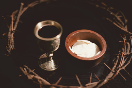 Communion bread and wine with the Holy Bible and crown of thorns, symbolizing the sacrifice of Jesus Christ, the passion, salvation and Christian faith in the Eucharist and Lord Supper.の写真素材