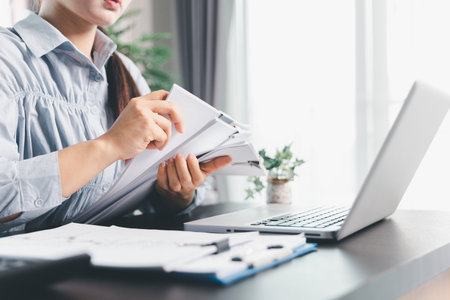 Business woman analyze calculate company financial, tax results office accounting statistics analytical research. calculating business balance prepare tax reduction. Tax deduction planning concept.の写真素材