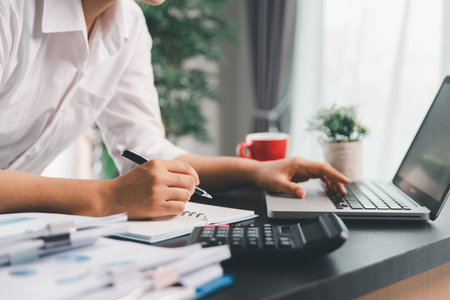 Business woman analyze calculate company financial, tax results office accounting statistics analytical research. calculating business balance prepare tax reduction. Tax deduction planning concept.の写真素材