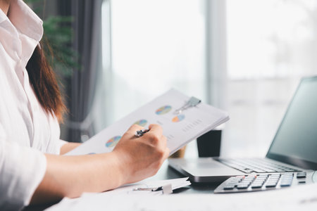 Business woman analyze calculate company financial, tax results office accounting statistics analytical research. calculating business balance prepare tax reduction. Tax deduction planning concept.の写真素材