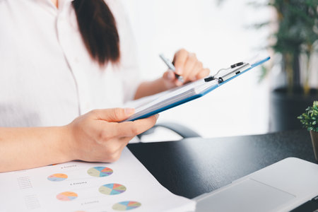 Business woman analyze calculate company financial, tax results office accounting statistics analytical research. calculating business balance prepare tax reduction. Tax deduction planning concept.の写真素材