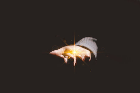 Hands holding glowing light, symbolizing hope, healing, faith, inspiration, spiritual energy, new beginning, miracle, inner strength and positive transformation from darkness to light.の写真素材
