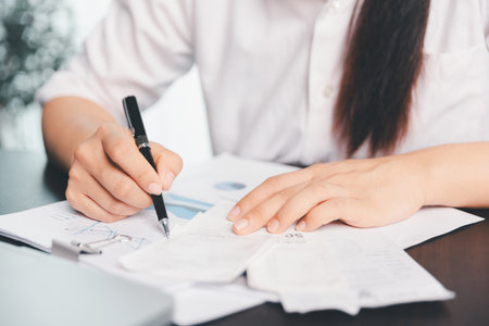 Business woman analyze calculate company financial, tax results office accounting statistics analytical research. calculating business balance prepare tax reduction. Tax deduction planning concept.の写真素材