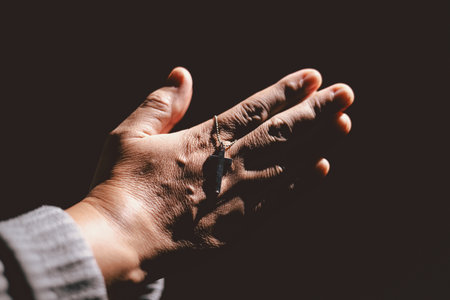 Person holding hands together in prayer gesture, symbolizing hope, faith, meditation, spirituality,...