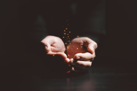 Hands holding glowing light, symbolizing hope, healing, faith, inspiration, spiritual energy, new beginning, miracle, inner strength and positive transformation from darkness to light.の写真素材